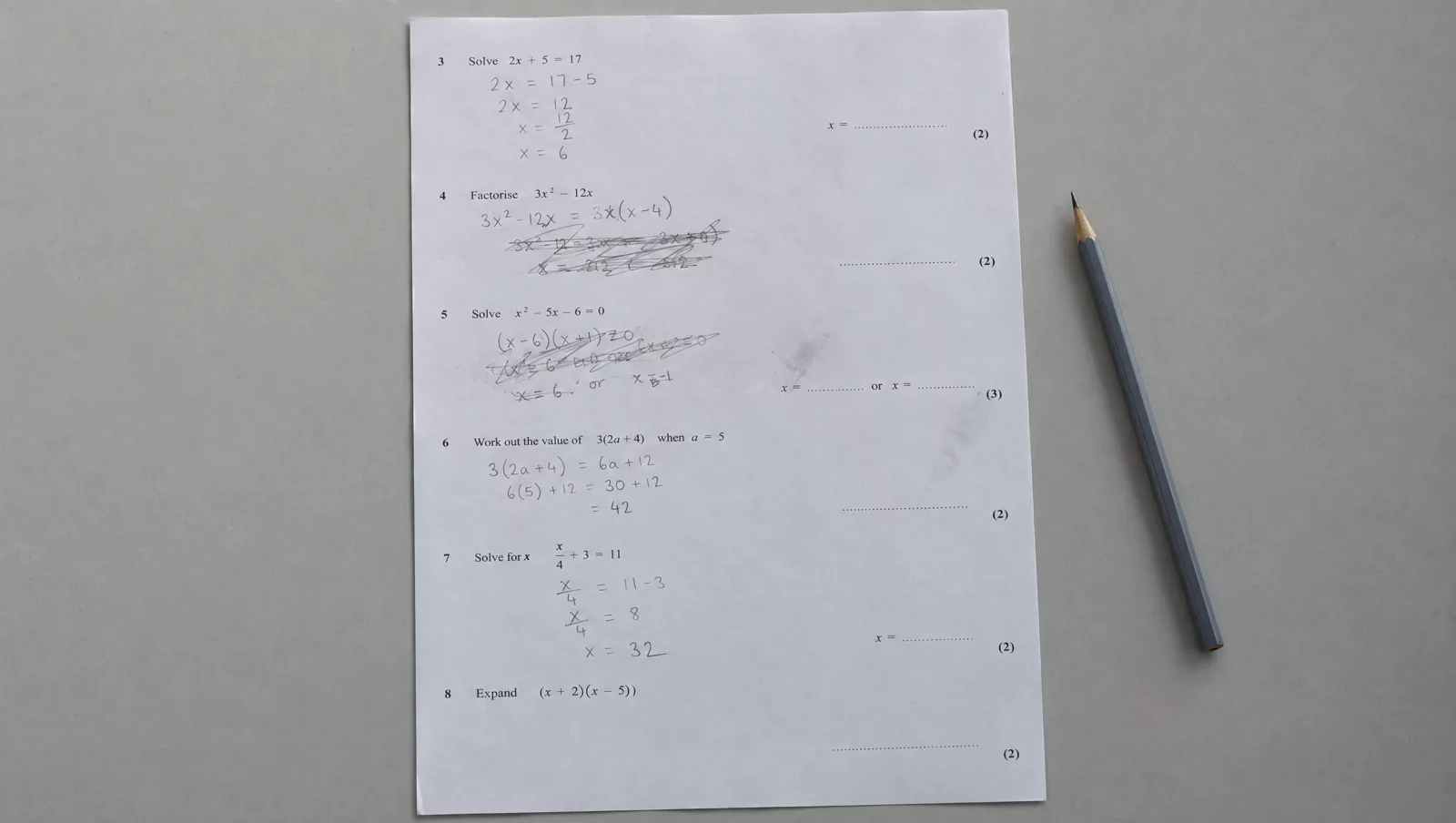 A past-paper answer from a first lesson, with gaps and crossings-out
